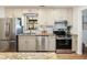 Galley kitchen featuring stainless steel appliances, granite countertops, and garden window at 2466 Thrasher Rd, Buford, GA 30519
