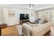 Spacious living room with modern decor, hardwood floors, and large TV at 2466 Thrasher Rd, Buford, GA 30519