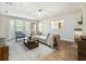 Well-lit living room with bay windows, hardwood floors, and comfortable seating at 2466 Thrasher Rd, Buford, GA 30519
