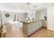 Open living area featuring a kitchen island, fireplace, and access to a deck through French doors at 2466 Thrasher Rd, Buford, GA 30519