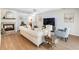 Bright living room featuring a fireplace, hardwood floors, and modern furnishings at 2466 Thrasher Rd, Buford, GA 30519