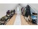 A very well organized walk-in closet with shoe racks and clothes rack at 2466 Thrasher Rd, Buford, GA 30519