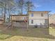 Exterior showcasing a wooden deck and a spacious yard with stairs and partial brick foundation at 4095 Kenora Sw Dr, Atlanta, GA 30331