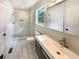 Modern bathroom featuring glass-enclosed shower, stylish vanity, and updated fixtures at 4095 Kenora Sw Dr, Atlanta, GA 30331