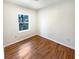 Bedroom with hardwood floors and a window view of the backyard at 4095 Kenora Sw Dr, Atlanta, GA 30331