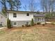 Charming home with a gray brick and white exterior and well-maintained landscaping, creating curb appeal at 4095 Kenora Sw Dr, Atlanta, GA 30331