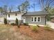 Charming home with a gray brick and white exterior and well-maintained landscaping, creating curb appeal at 4095 Kenora Sw Dr, Atlanta, GA 30331