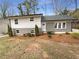 Charming home with a gray brick and white exterior and well-maintained landscaping, creating curb appeal at 4095 Kenora Sw Dr, Atlanta, GA 30331