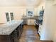 Bright kitchen features stainless appliances, granite countertops and a center island at 4095 Kenora Sw Dr, Atlanta, GA 30331