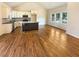 Bright living room adjacent to kitchen featuring hardwood floors and vaulted ceilings at 4095 Kenora Sw Dr, Atlanta, GA 30331