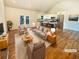 Bright living room featuring hardwood floors, neutral furniture, and access to outdoor deck at 4095 Kenora Sw Dr, Atlanta, GA 30331