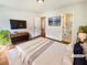 Tranquil main bedroom with hardwood floors, a TV, and an en-suite bathroom with shower at 4095 Kenora Sw Dr, Atlanta, GA 30331