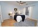 Stylish bedroom with modern decor, light hardwood floors, a ceiling fan, and a large window, creating a relaxing retreat at 821 Ralph Mcgill Ne Blvd # 3209, Atlanta, GA 30306