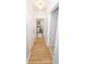 Well-lit hallway with hardwood floors, leading to a bedroom and bathroom, providing a seamless transition between spaces at 821 Ralph Mcgill Ne Blvd # 3209, Atlanta, GA 30306
