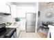 Galley kitchen with stainless steel refrigerator and modern lighting leading to dining area at 821 Ralph Mcgill Ne Blvd # 3209, Atlanta, GA 30306
