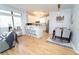 Open-concept living area features wood floors, modern light fixture, and stainless steel appliances at 821 Ralph Mcgill Ne Blvd # 3209, Atlanta, GA 30306