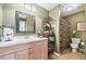 Olive-green bathroom features a single sink vanity, mirror, and patterned shower curtain at 1168 Blackhawk Pl, Lawrenceville, GA 30043