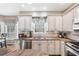 Kitchen with stainless steel appliances, white cabinets, granite countertops, and tile backsplash at 1168 Blackhawk Pl, Lawrenceville, GA 30043