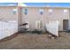 Townhouse backyard and patio with table, swing, grass and white privacy fence at 156 Haven Oak Way, Lawrenceville, GA 30044