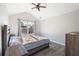 Bedroom with vaulted ceiling has a ceiling fan, bright window, bed and dresser at 156 Haven Oak Way, Lawrenceville, GA 30044