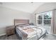 Bedroom boasts a vaulted ceiling, bright window, bed and updated flooring at 156 Haven Oak Way, Lawrenceville, GA 30044