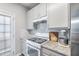 Well-lit kitchen featuring modern appliances and granite countertops at 156 Haven Oak Way, Lawrenceville, GA 30044