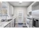 Modern kitchen features stainless steel appliances, granite countertops and door leading to the backyard at 156 Haven Oak Way, Lawrenceville, GA 30044