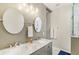 Modern bathroom features double sinks, a stone countertop, and decorative mirrors at 2418 Bolling Brook Sw Dr, Atlanta, GA 30311