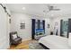 Spacious primary bedroom with barn door, hardwood floors, and ensuite bathroom at 2418 Bolling Brook Sw Dr, Atlanta, GA 30311
