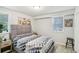 Cozy bedroom featuring a queen-sized bed, stylish rug, and ample natural light from two windows at 2418 Bolling Brook Sw Dr, Atlanta, GA 30311