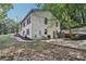 White brick home with mature trees, a well-maintained lawn, and a walkway leading to the backyard at 2418 Bolling Brook Sw Dr, Atlanta, GA 30311