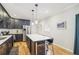 Contemporary kitchen featuring dark cabinetry, stainless steel appliances, and a central island with barstool seating at 2418 Bolling Brook Sw Dr, Atlanta, GA 30311