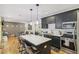 Open-concept kitchen with a central island, modern appliances, and hardwood floors connecting to the cozy living room at 2418 Bolling Brook Sw Dr, Atlanta, GA 30311