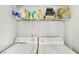 Bright laundry room with shelving above the washer and dryer hookups at 2418 Bolling Brook Sw Dr, Atlanta, GA 30311