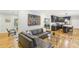 Open-concept living space with hardwood floors, modern decor, and seamless flow to the kitchen and dining areas at 2418 Bolling Brook Sw Dr, Atlanta, GA 30311