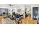 Spacious living room with hardwood floors connecting to the dining room and a secondary seating area with fireplace at 2418 Bolling Brook Sw Dr, Atlanta, GA 30311