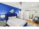Stylish primary bedroom with elegant blue accent wall, hardwood floors, and an ensuite bathroom at 2418 Bolling Brook Sw Dr, Atlanta, GA 30311
