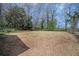 Large backyard featuring dry grass, bare trees and a partial view of the back of the house at 3162 Alston Dr, Decatur, GA 30032
