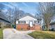 Charming single-story home with a brick facade and a well-manicured lawn and a curved driveway at 3162 Alston Dr, Decatur, GA 30032