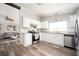 Modern kitchen boasts stainless steel appliances, white cabinetry, and granite countertops at 3162 Alston Dr, Decatur, GA 30032