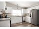 Modern kitchen featuring white cabinetry, granite countertops, and stainless steel appliances at 3162 Alston Dr, Decatur, GA 30032