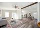 Open-concept living room with hardwood floors, ceiling fan, and view into the dining and kitchen areas at 3162 Alston Dr, Decatur, GA 30032