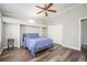 Primary bedroom with tray ceiling, built-in shelves, hardwood floors, and a double-door closet at 3162 Alston Dr, Decatur, GA 30032