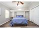Primary bedroom with tray ceiling, built-in shelves, hardwood floors, and a double-door closet at 3162 Alston Dr, Decatur, GA 30032