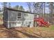 Exterior view of home with a red staircase leading to the upper level and a lush green lawn at 3576 Shrewsbury Ct, Snellville, GA 30039