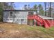 Exterior view of home with a red staircase leading to the upper level and a lush green lawn at 3576 Shrewsbury Ct, Snellville, GA 30039