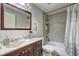 Bathroom featuring a vanity with dark wood cabinets, a large mirror, and a shower-tub combination at 3576 Shrewsbury Ct, Snellville, GA 30039