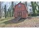Exterior view of a shed on the lot with a rustic barn design and a wooden ramp at 3576 Shrewsbury Ct, Snellville, GA 30039