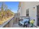 Private balcony with wood railings, seating, and view of surrounding trees at 420 Heritage Park Nw Trce # 22, Kennesaw, GA 30144