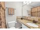 Bathroom featuring granite countertop, a large mirror, decorative shower curtain and tiled walls at 420 Heritage Park Nw Trce # 22, Kennesaw, GA 30144